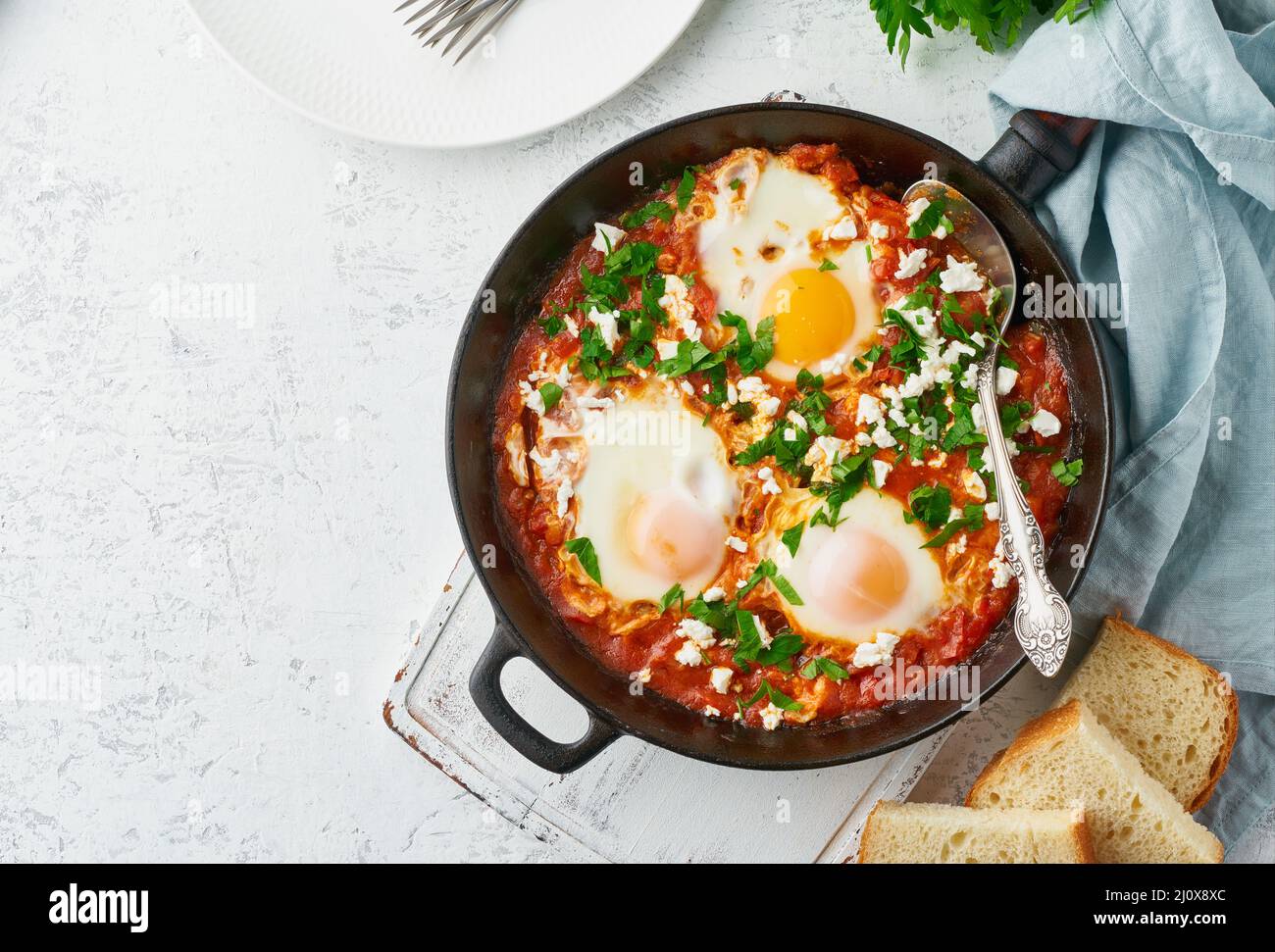 Shakshouka, œufs pochés dans une sauce aux tomates, huile d'olive. Cuisine méditerranéenne. Banque D'Images