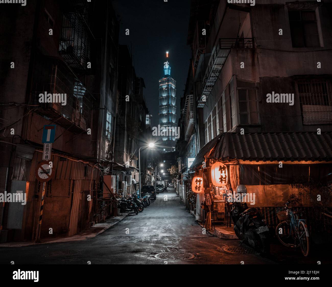 Une vue populaire de Taipei 101 depuis une allée la nuit, avec un restaurant japonais izakaya populaire en premier plan. Banque D'Images