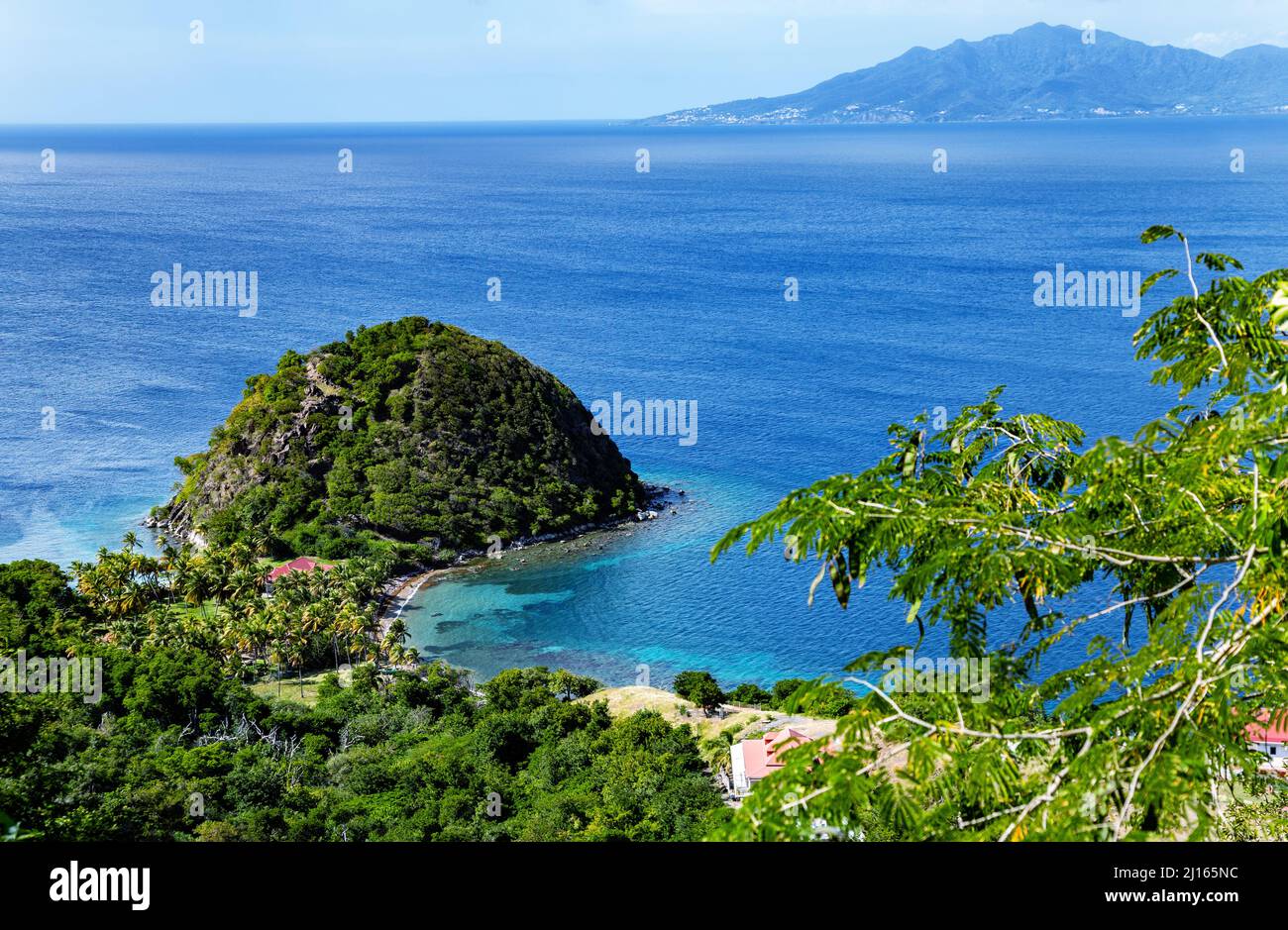 Roche de la douleur du sucre, Terre-de-Haut, Iles des Saintes, les Saintes, Guadeloupe, Antilles néerlandaises, Caraïbes. Île Basse-Terre en arrière-plan. Banque D'Images