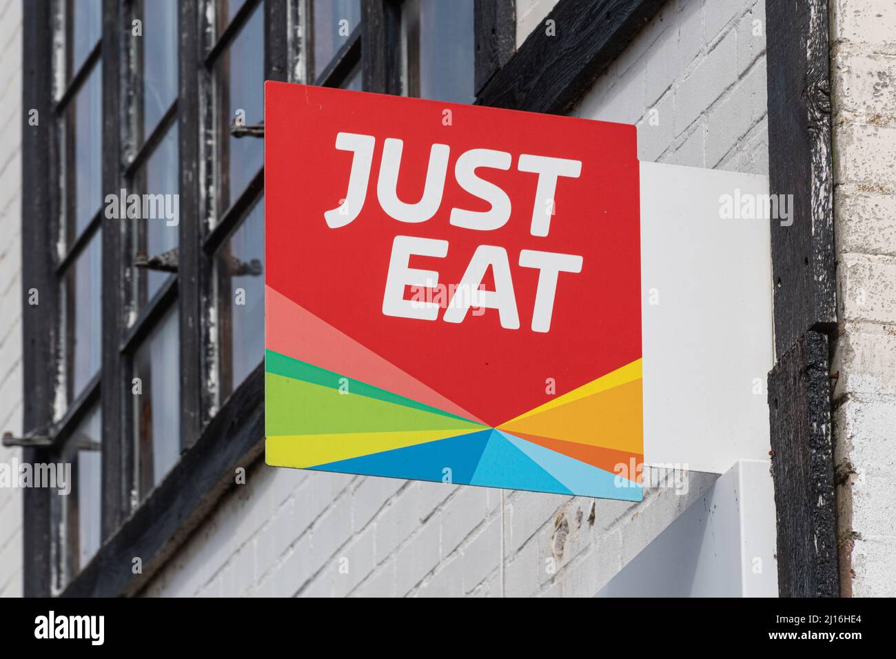 Affiche et logo Just Eat à l'extérieur d'un restaurant à emporter à Surrey, Royaume-Uni, service de commande et de livraison de nourriture en ligne Banque D'Images