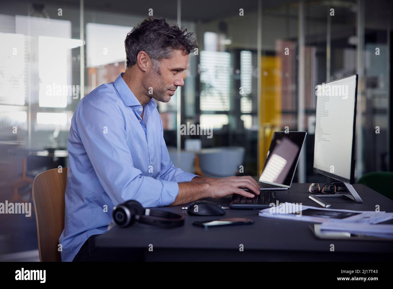 Homme d'affaires utilisant un ordinateur travaillant au bureau Banque D'Images