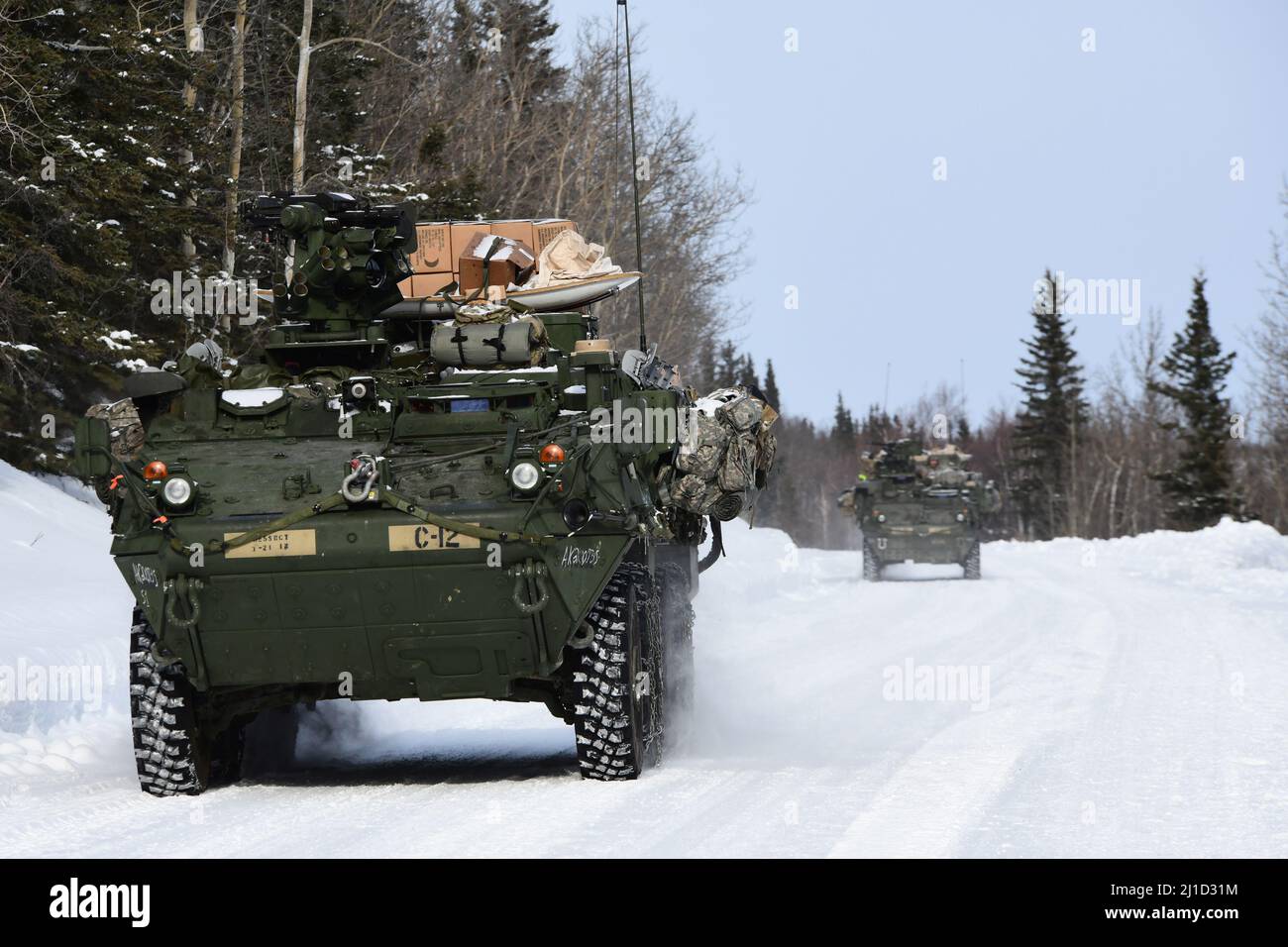 Les véhicules Stryker du 3rd Bataillon, 21st Infantry Regiment descendent une route enneigée dans la zone d'entraînement de Donnelly lors du joint Pacific multinational Readiness Centre 22-02, le 22 mars 2022. Cet exercice est conçu pour valider l’entraînement, la préparation et les capacités par temps froid de l’équipe de combat de la Brigade Stryker de l’Alaska 1st de l’Armée américaine, 25th de la Division d’infanterie. (Photo de l'armée/John Pennell) Banque D'Images