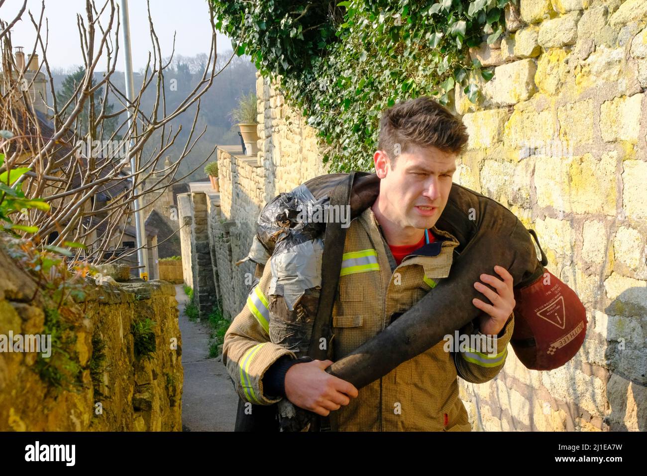 Bradford-on-Avon, Royaume-Uni. 25th mars 2022. James Compton collecte de l'argent pour les organismes de bienfaisance des services d'urgence en portant un mannequin de 70kg sur les collines de Bradford-on-Avon, une jolie mais très vallonnée ville de Wiltshire. Pendant 3 jours, 20 courses par jour, James escaladera l'équivalent de Snowdon. James, qui est pompier sur appel, tente de recueillir des fonds pour 3 œuvres caritatives Blue Light : police Care UK, Fire Fighters Charity et Ambulance Staff Charity. Crédit : JMF News/Alay Live News Banque D'Images