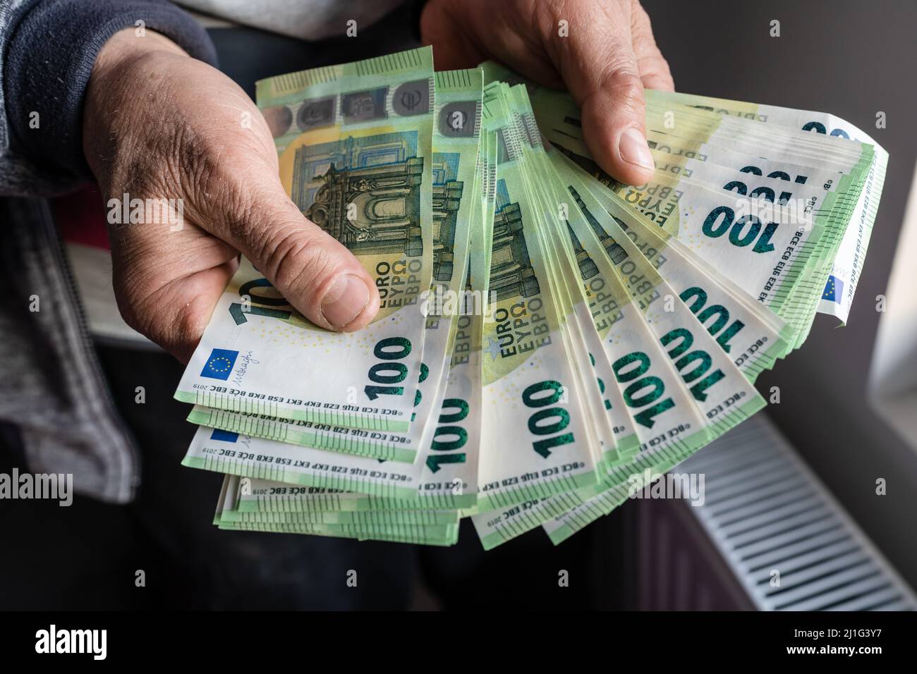 Gros plan sur les mains d'un homme âgé caucasien inconnu détenant et comptant 100 billets en euros argent paiement d'assurance de patrimoine ou copie d'épargne à vie spac Banque D'Images