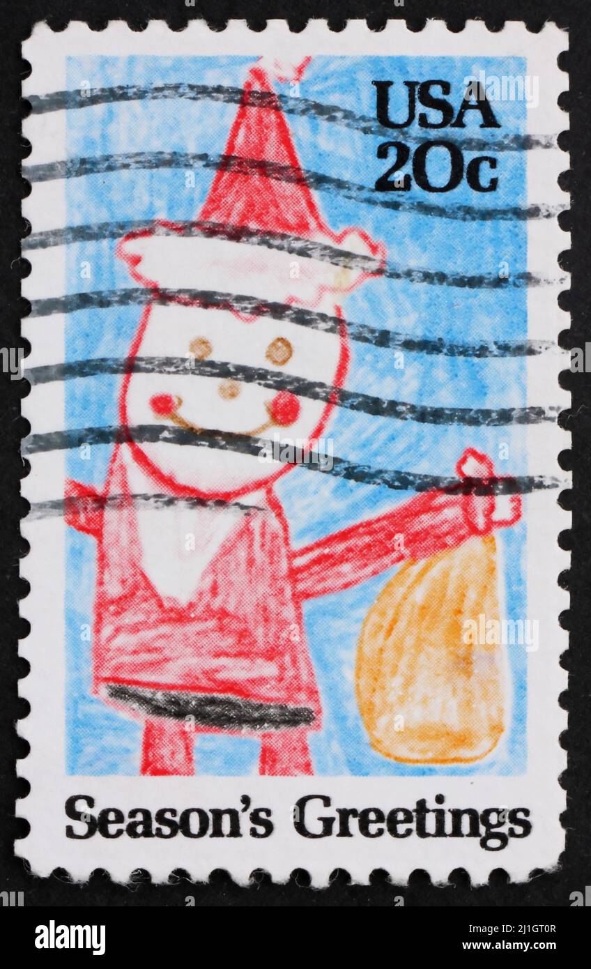 ÉTATS-UNIS D'AMÉRIQUE - VERS 1984 : un timbre imprimé aux États-Unis d'Amérique montre le dessin des enfants du Père Noël avec des cadeaux, vers 1984 Banque D'Images