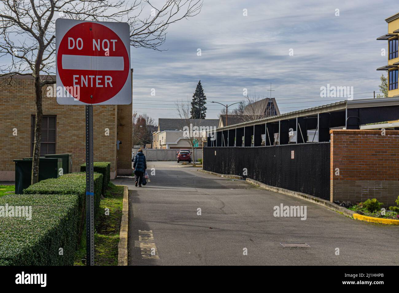 N'entrez pas l'affiche devant la ruelle lorsque la personne s'éloigne vers la ligne de clôture. Banque D'Images