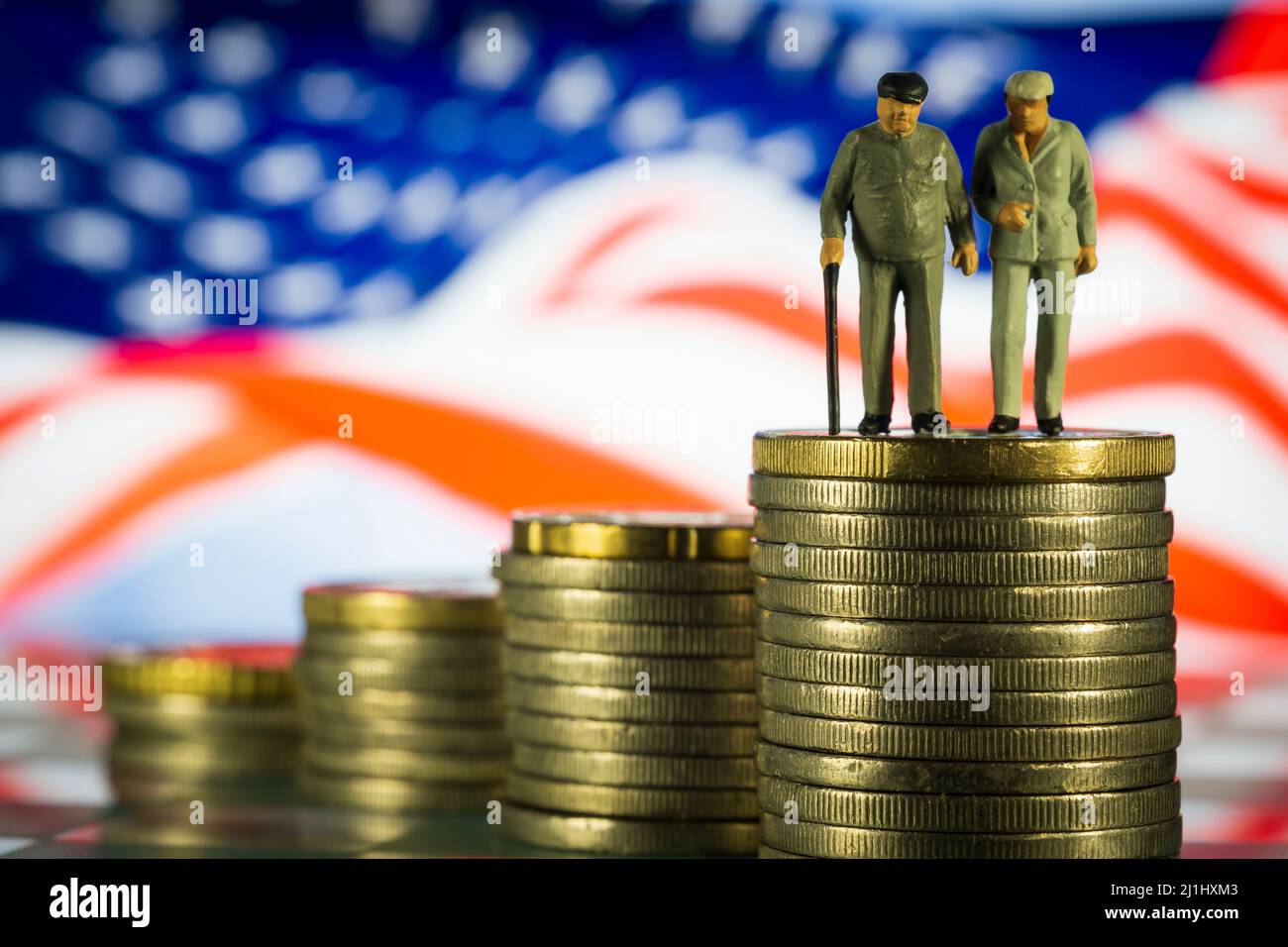 Miniature personnes vieux couple marchant avec une canne en verre échecs États-Unis drapeau arrière-plan. Concept de la stratégie de retraite Banque D'Images