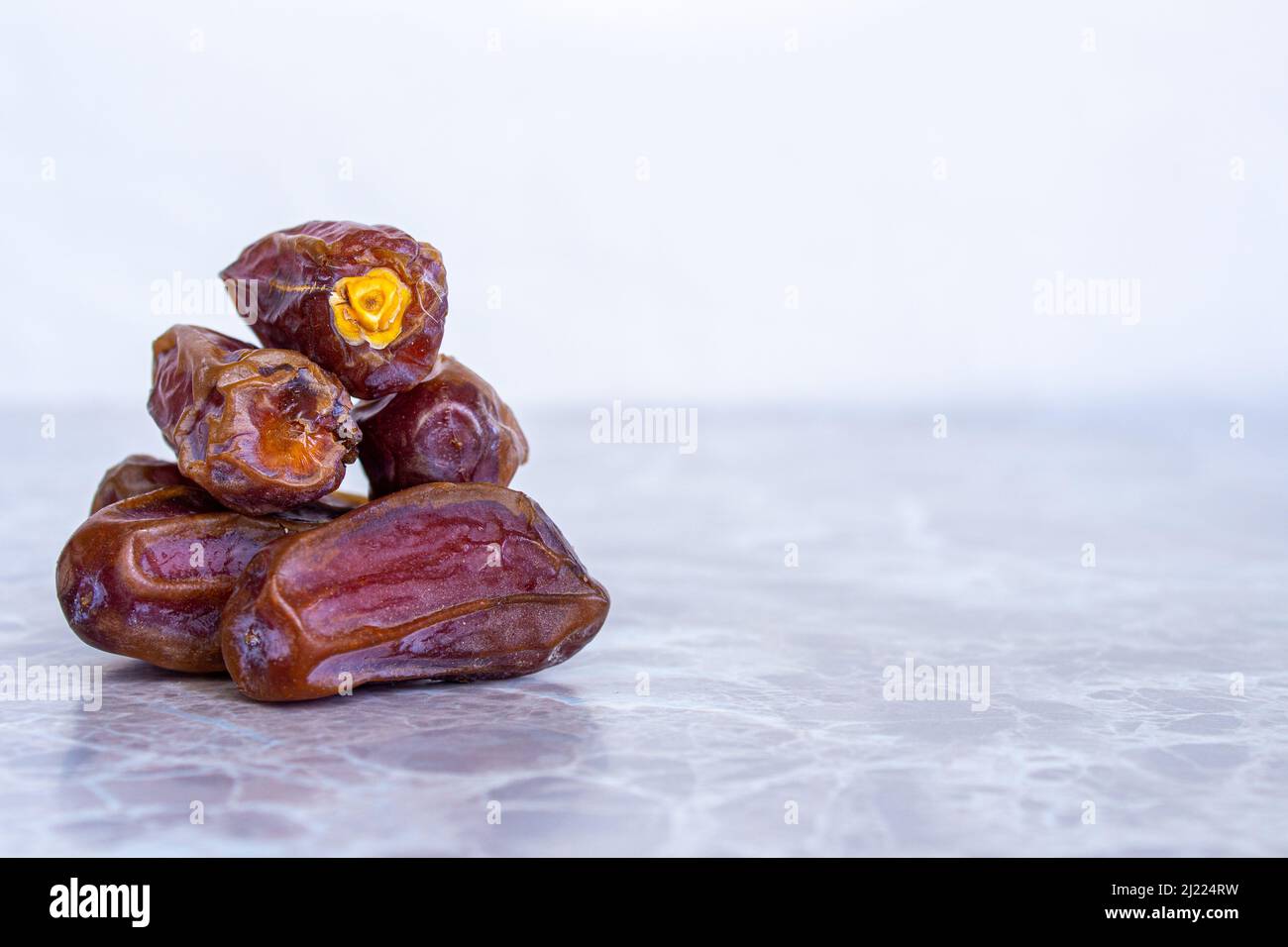 Fruits dattes séchés sur une table en marbre. Gros plan de dates mûres avec espace pour le texte. Nourriture traditionnelle iftar pour les musulmans. Banque D'Images