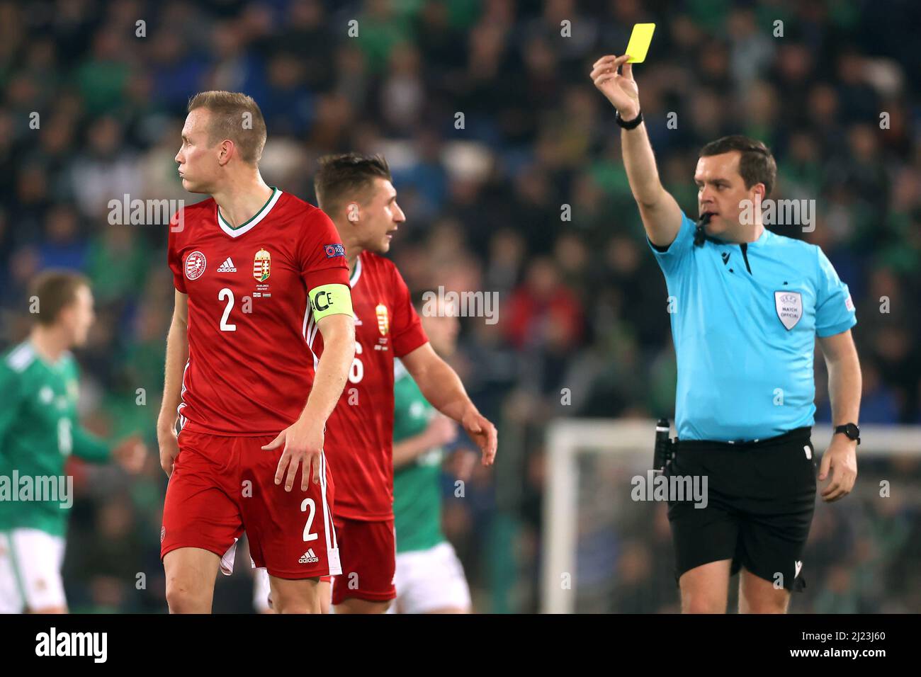 L'arbitre Rob Harvey (à droite) montre une carte jaune à Adam Lang (à gauche) de Hongrie pour un scandale lors du match international amical à Windsor Park, Belfast. Date de la photo: Mardi 29 mars 2022. Banque D'Images