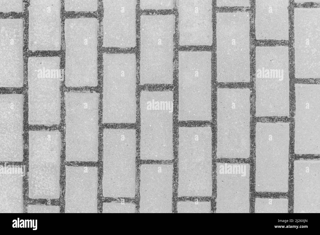 Trottoir gris carrelage rue pierre ville route abstrait modèle urbain design texture revêtement arrière-plan. Banque D'Images