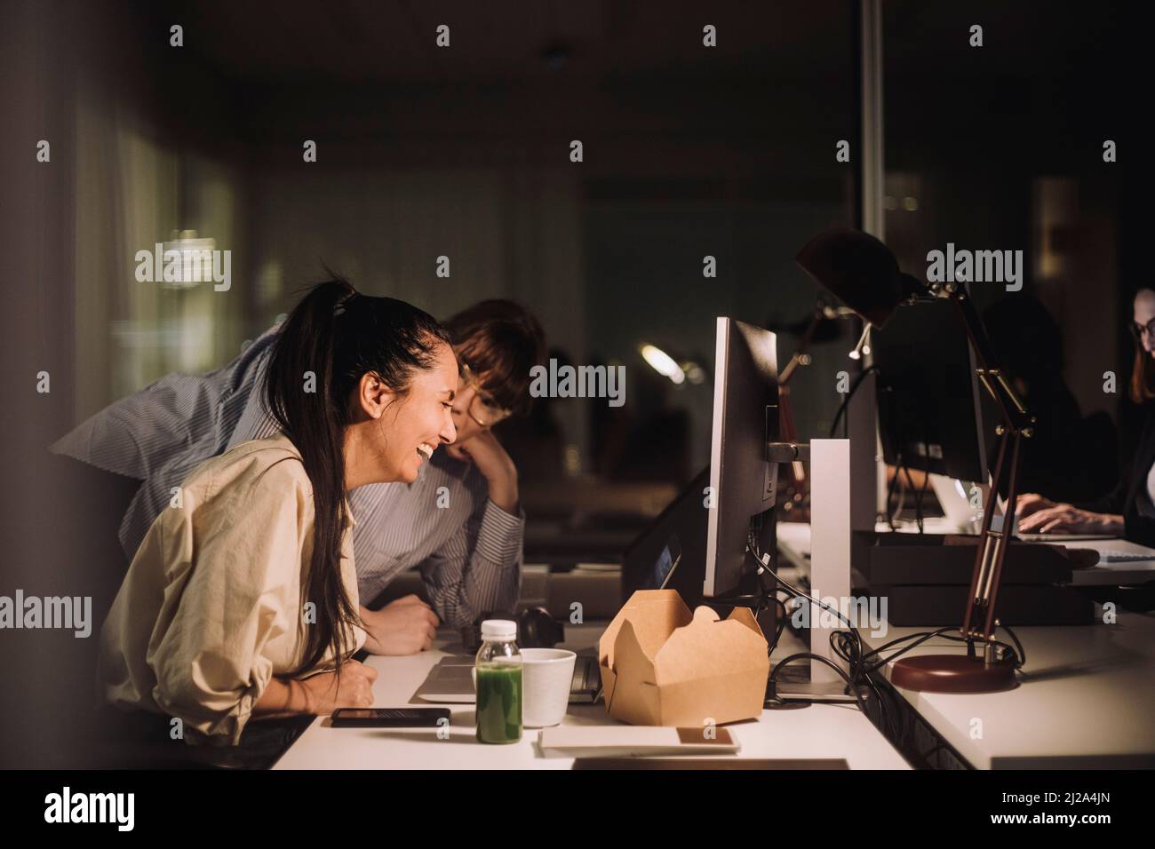 Bonne femme d'affaires discutant avec une collègue à la réception au bureau Banque D'Images