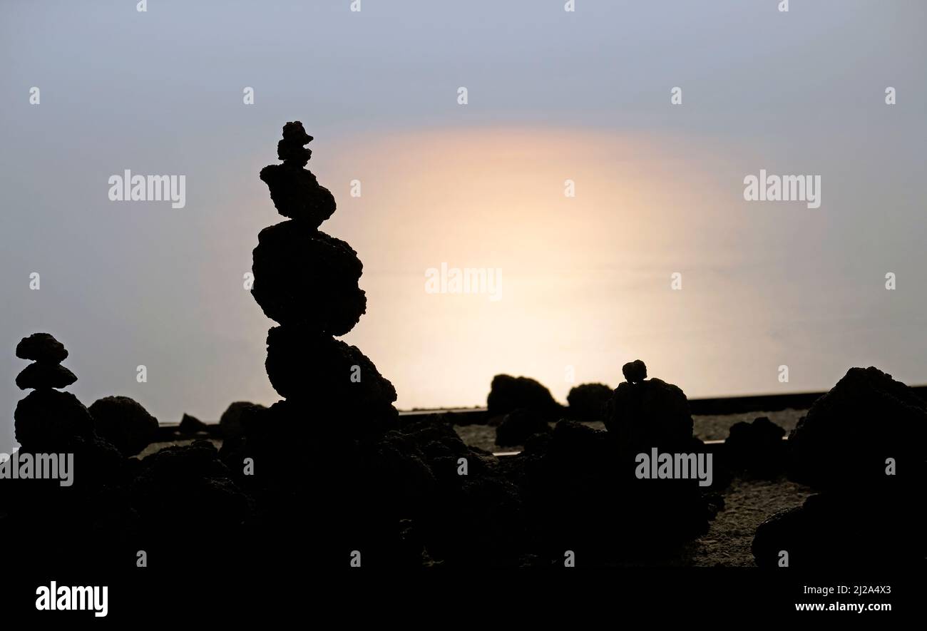 Galets empilés sur le Vésuve au coucher du soleil avec l'océan en arrière-plan Banque D'Images