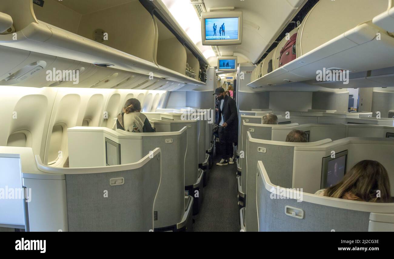 Les passagers montent à bord d'une cabine de classe affaires en avion pendant la pandémie Covid 19 Banque D'Images