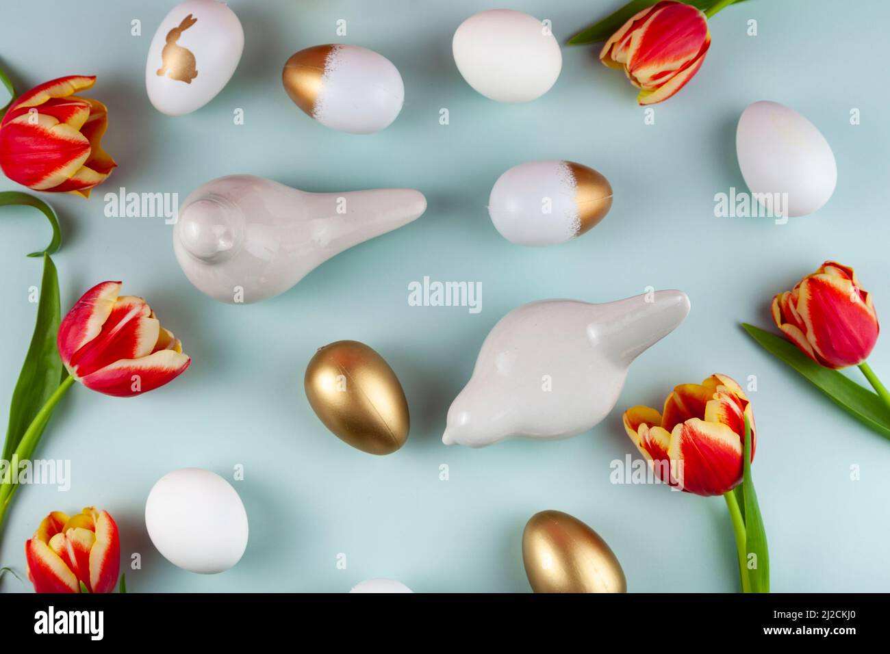 Fleurs de tulipes, oiseaux et œufs de pâques sur fond vert. Vue de dessus avec espace de copie. Carte de vœux joyeuses Pâques Banque D'Images