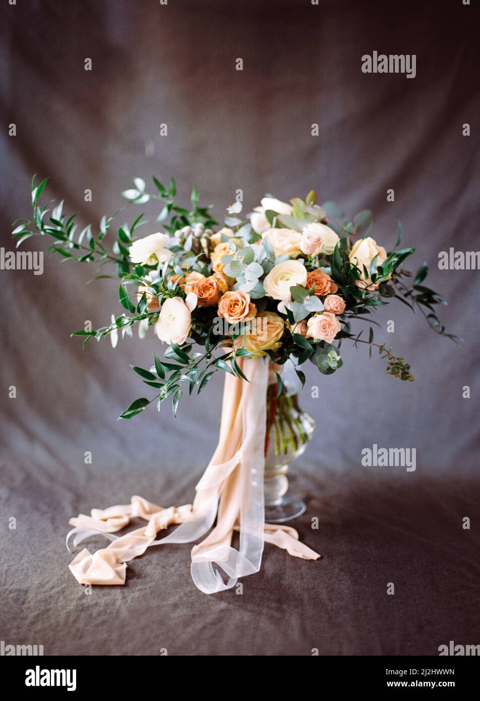 Bouquet moderne dans les tons pêche et beige sur fond gris foncé. Carte d'invitation à la fleur. Inspiration élégante pour un mariage. Banque D'Images