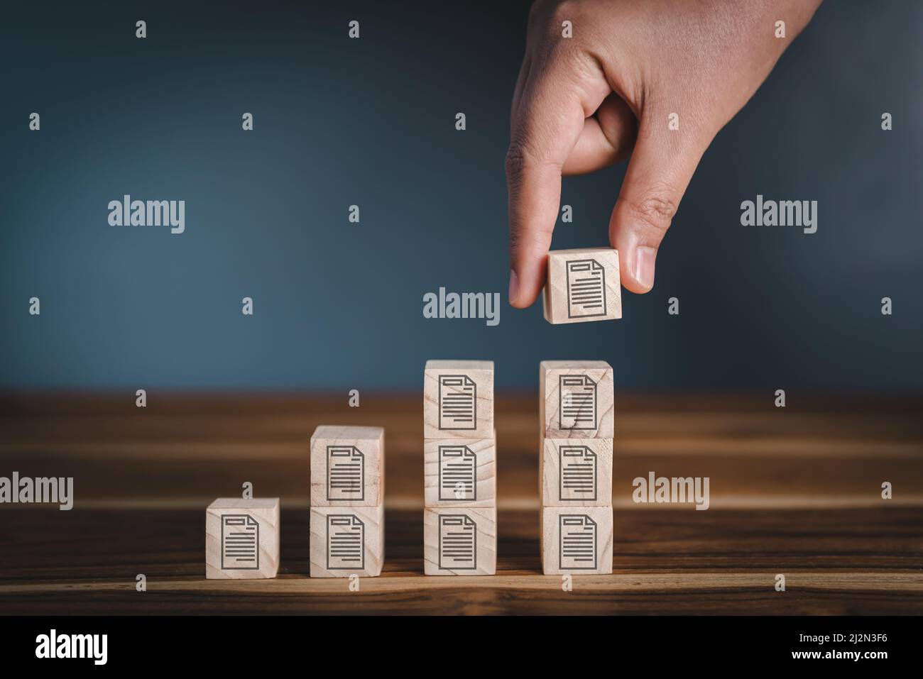 Base de données Documentation gestion des fichiers tendance concept, la main met le cube en bois avec l'icône de fichier stockage de superposition. Plan stratégique et système de stockage f Banque D'Images