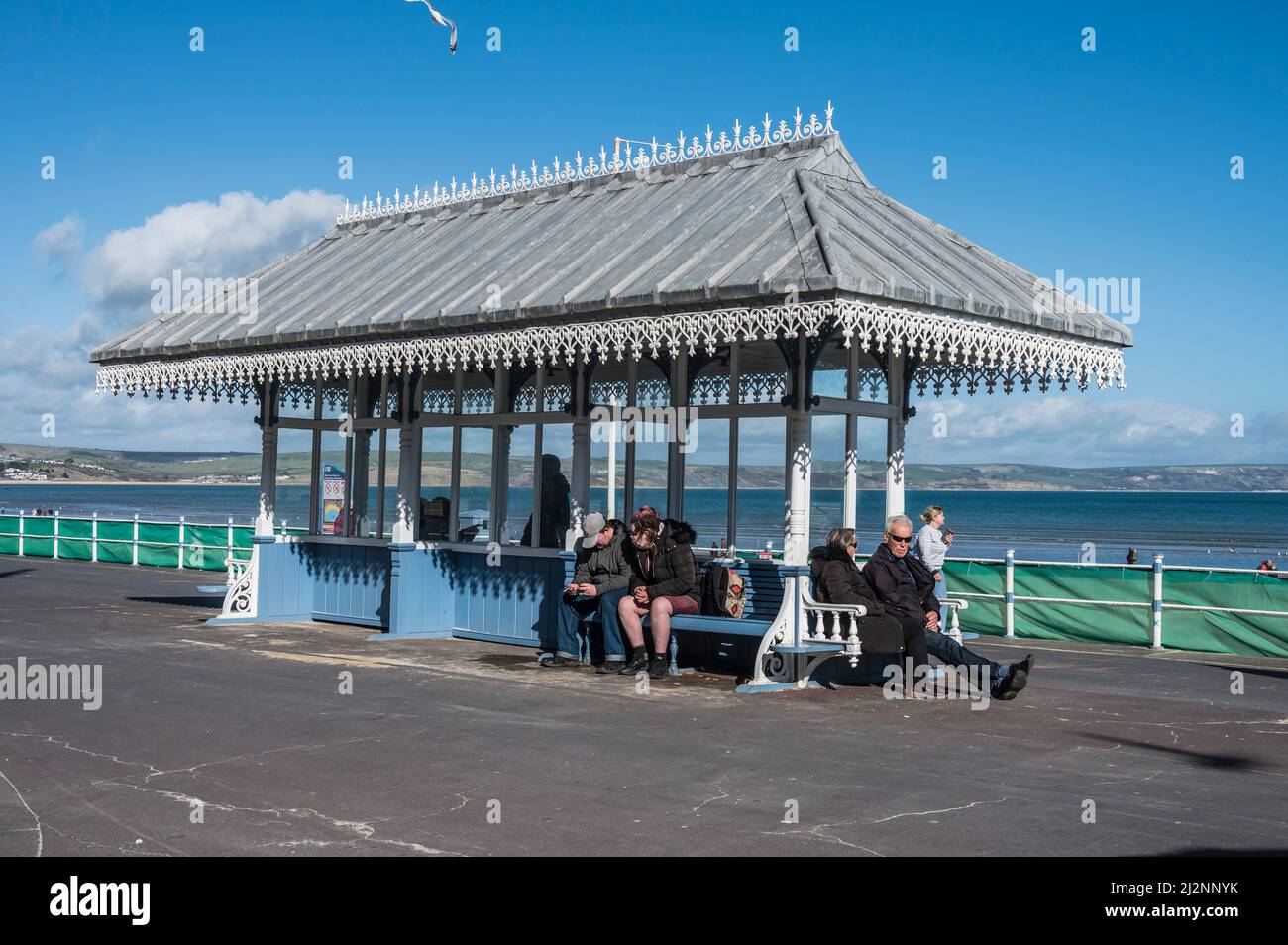 Des scènes colorées de vacanciers se détendent sur la promenade de l'Esplanade de Weymouth qui surplombe la baie de Weymouth Banque D'Images