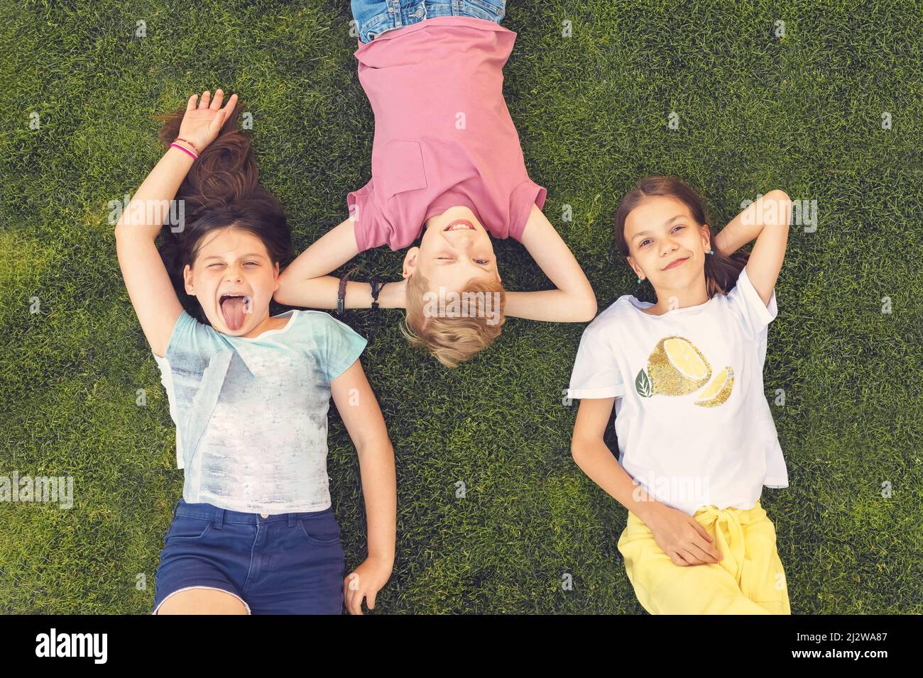 Des enfants heureux qui s'amusent l'été font des visages amusants en plein air Banque D'Images