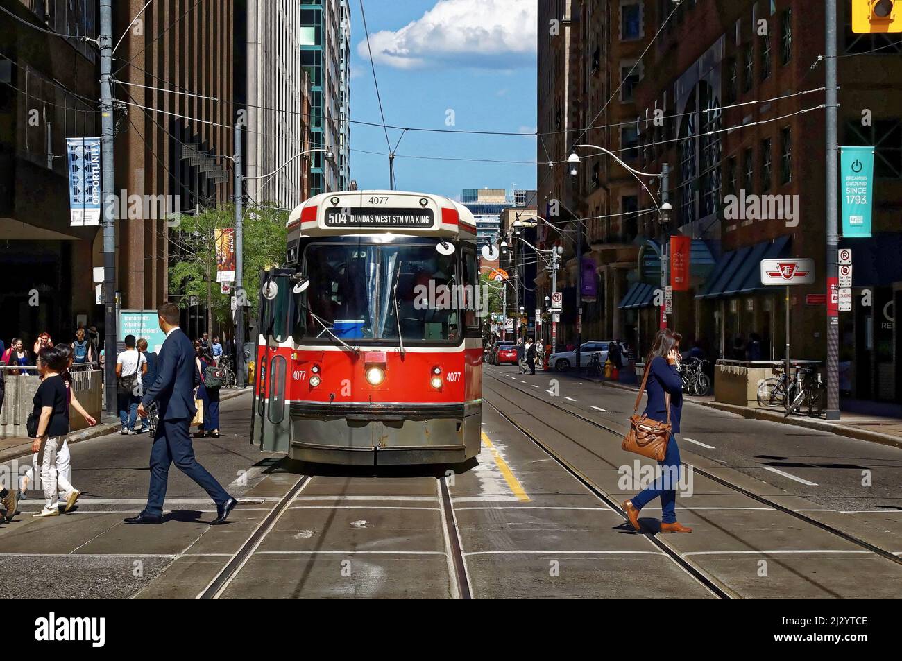 TORONTO, CANADA - 06 27 2016 : les habitants de la ville traversent la rue en face d'un ancien tramway sur King à l'intersection de Younge St Banque D'Images