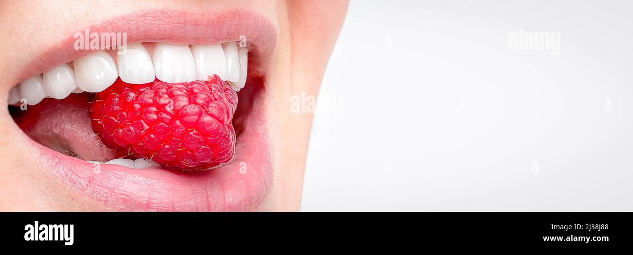 Bannière sourire blanc parfait gros plan, le sourire en plaqué femelle avec la grande framboise rouge, les soins dentaires et le copyspace stomatologie Banque D'Images