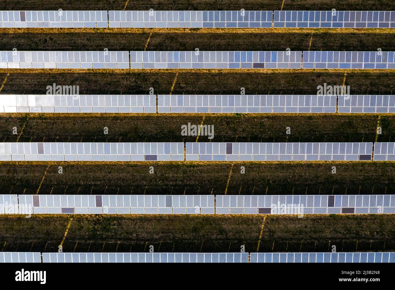 Gros plan symétrique des panneaux solaires d'un système photovoltaïque sur un parc solaire en Allemagne du point de vue d'un drone Banque D'Images