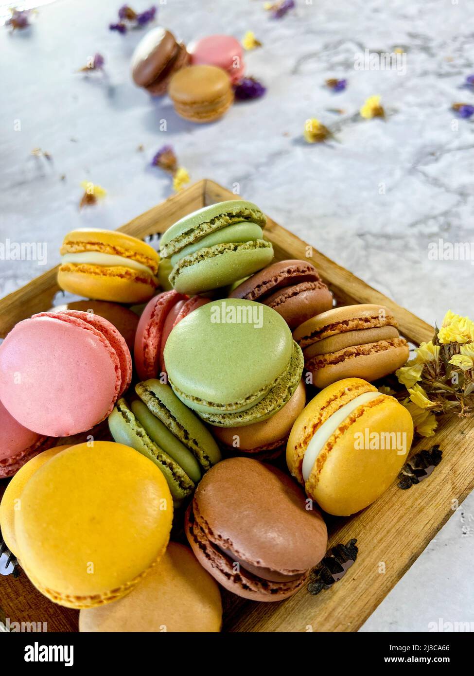 Macarons français colorés sur fond de marbre blanc vu d'en haut. Banque D'Images