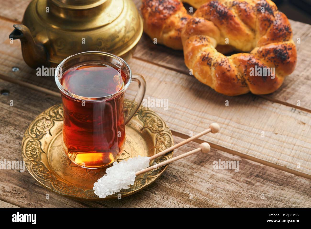 Thé noir turc. Tasse en verre de thé noir turc et bagel traditionnel turc croustillant sur fond de vieux rousstick. Concept de pâtisserie pour le petit déjeuner. Traditiona Banque D'Images
