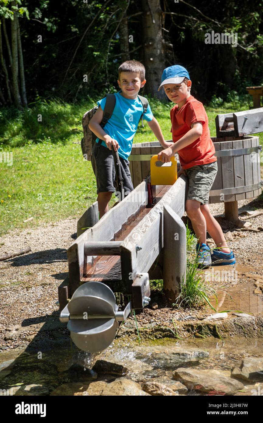 France, haute Savoie (74) massif du Mont blanc , les Contamines Montjoie, espace de jeux de l'Etape, des enfants jouants avec des vannes de la rivière artificielle en bois Banque D'Images