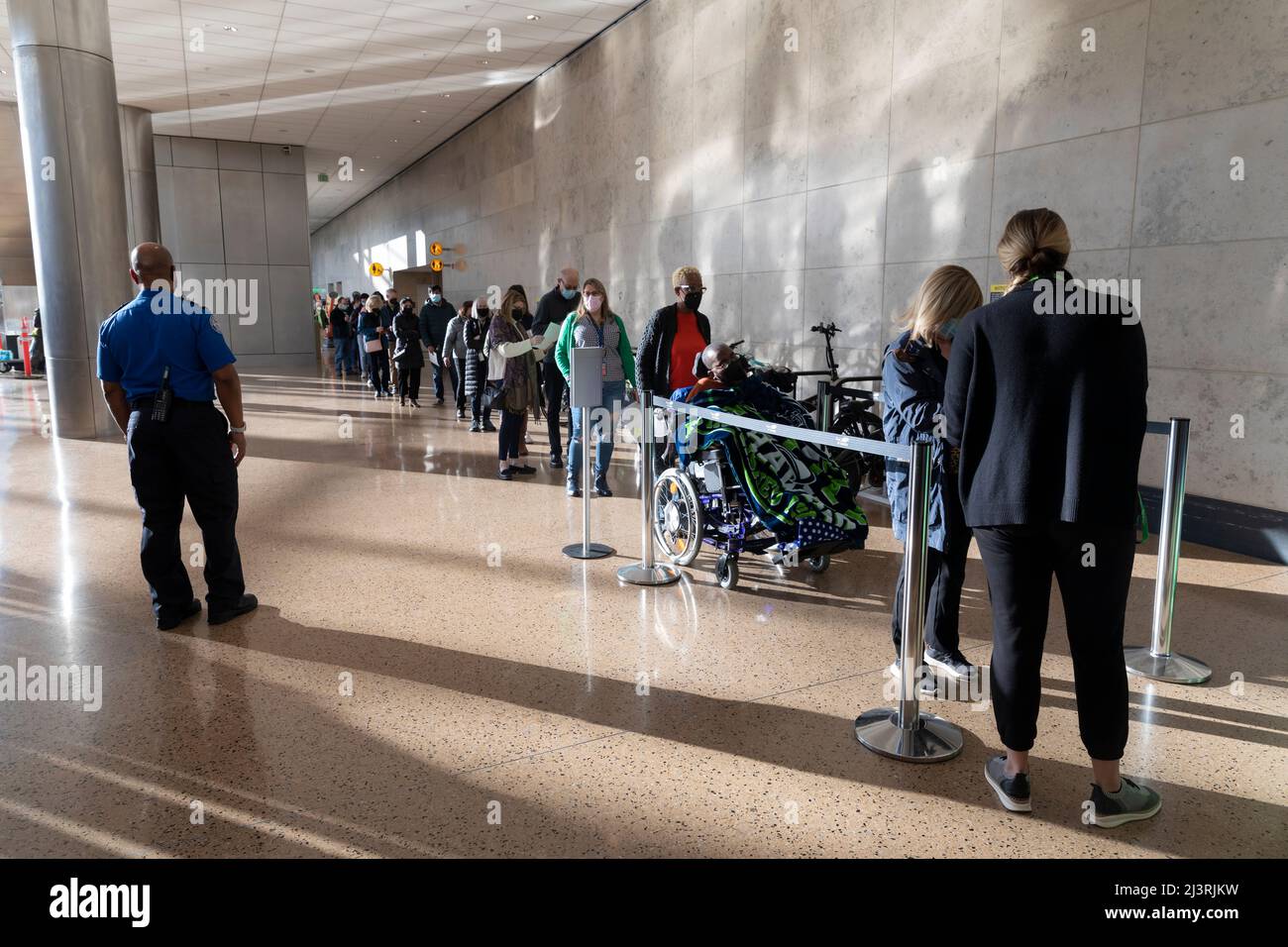 SeaTac, Washington, États-Unis. 9th avril 2022. Un agent de la TSA surveille les bénévoles pendant qu'ils se mettent à effectuer un contrôle de sécurité lors d'une simulation de circulation des passagers au site des arrivées internationales de l'aéroport international de Seattle-Tacoma. La nouvelle installation du port de Seattle, d’une superficie de 450 000 000 pieds carrés, devrait ouvrir le mois prochain après l’achèvement des tests de préparation opérationnelle finaux. Crédit : Paul Christian Gordon/Alay Live News Banque D'Images