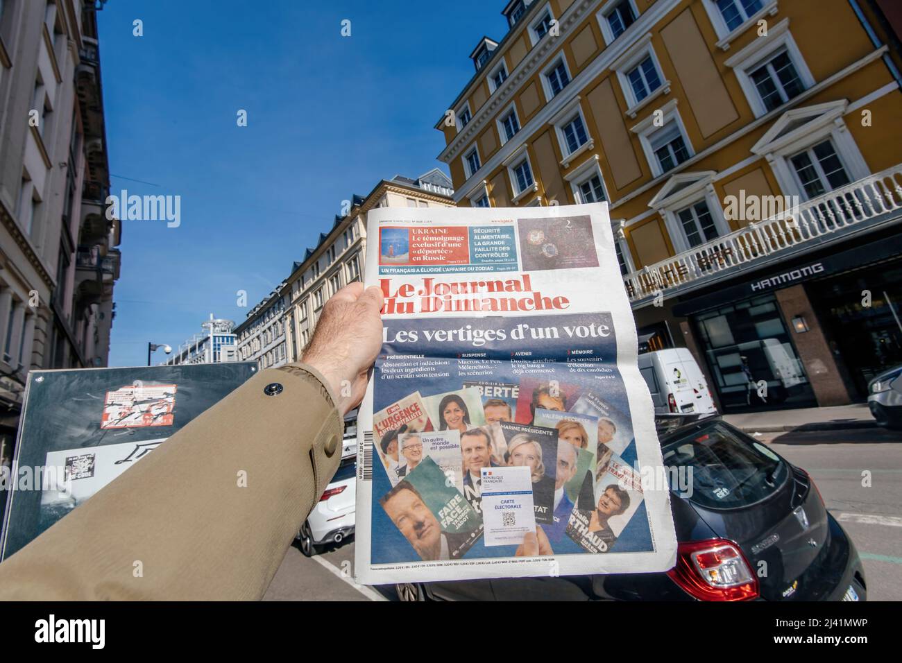 Paris, France - 11 avril : un homme lisant dans la ville le Journal du Dimanche présentant tous les candidats au premier tour de l'élection présidentielle française du 10 2022 avril Banque D'Images