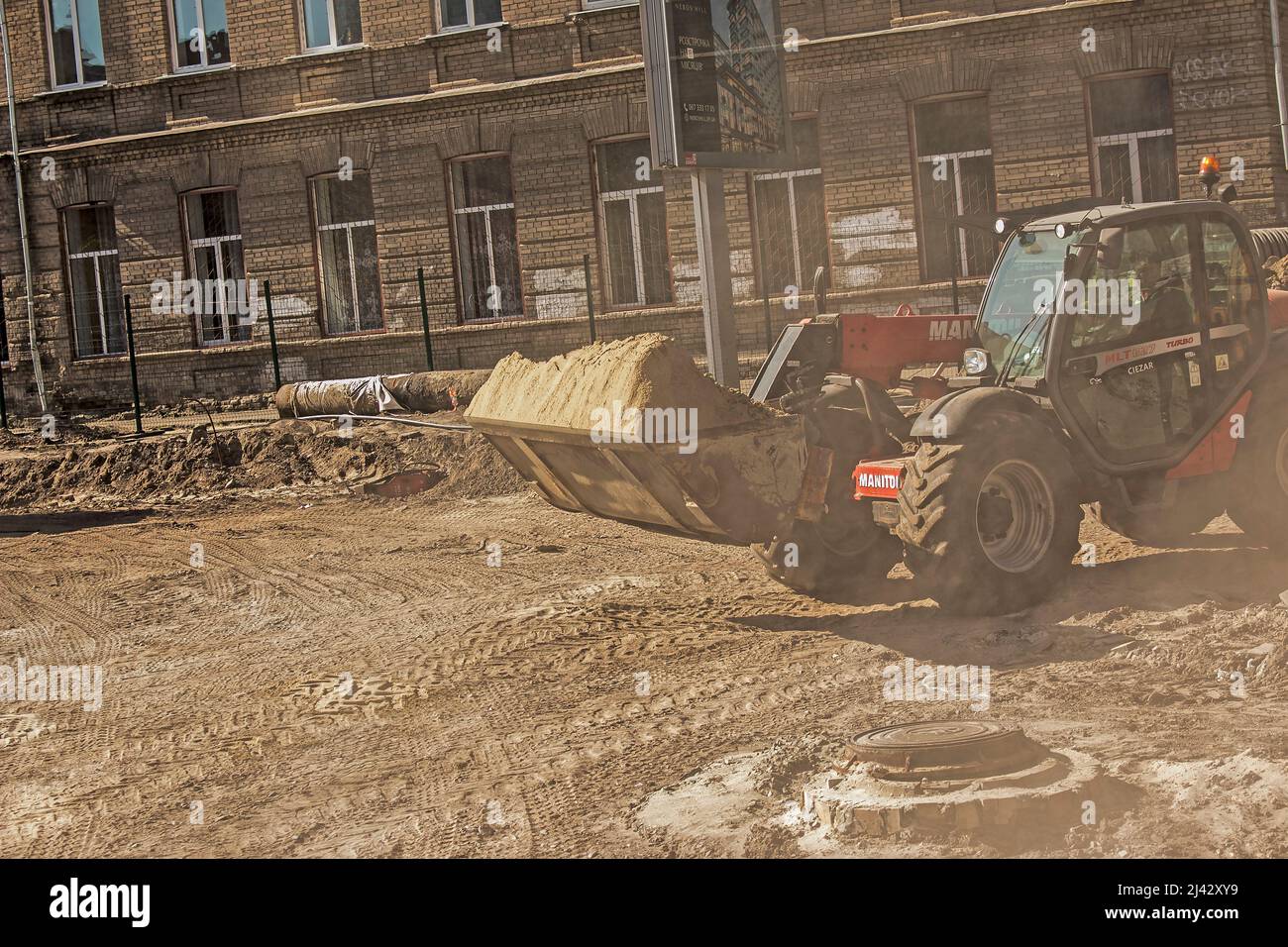 Dnepropetrovsk, Ukraine - 10.05.2021: La niveleuse prend le sable. Les ouvriers de la construction préparent le site. Banque D'Images