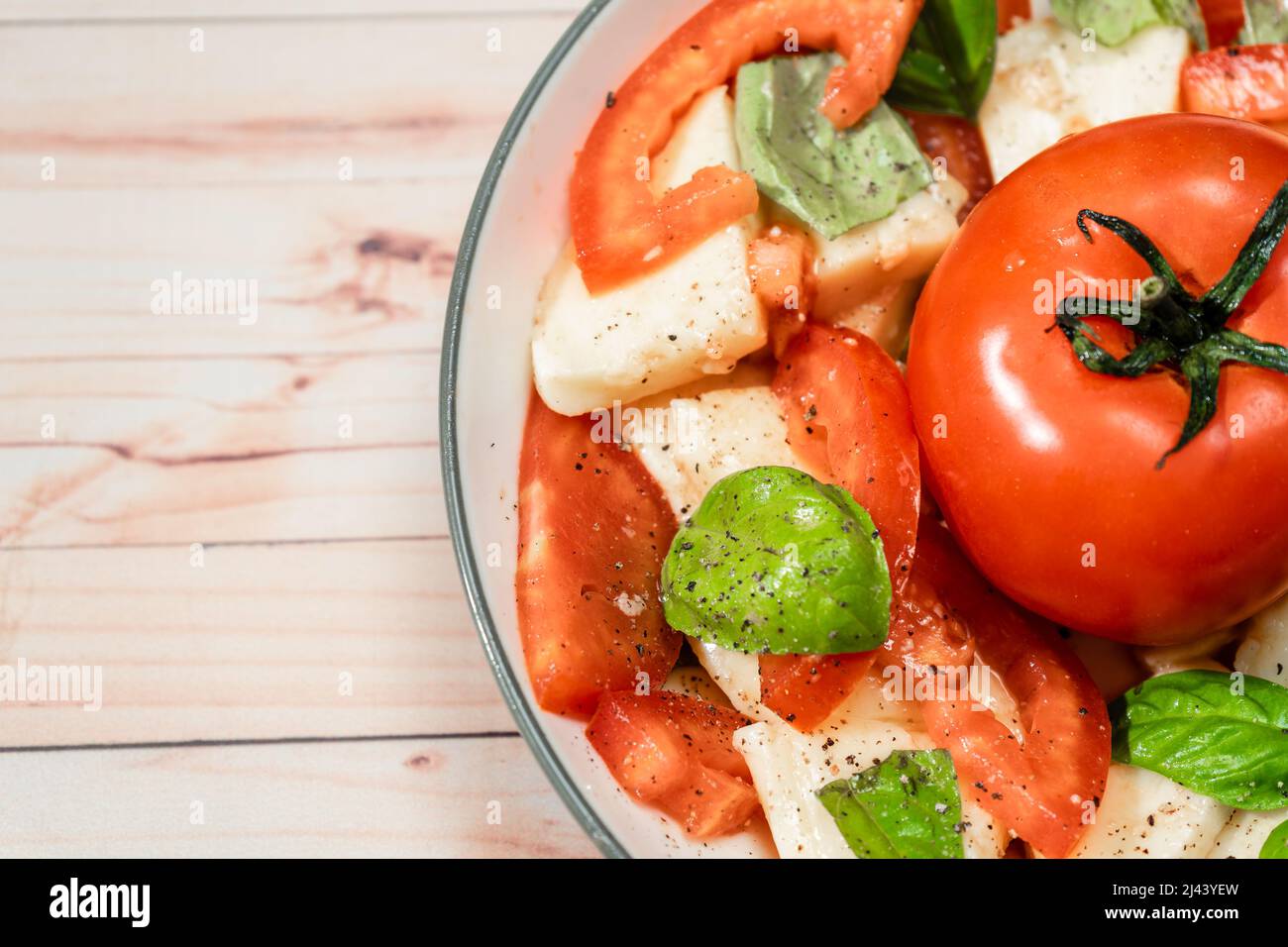 Salade italienne classique de mozzarella, tomate et basilic avec huile d'olive et vinaigre. Gros plan. Banque D'Images