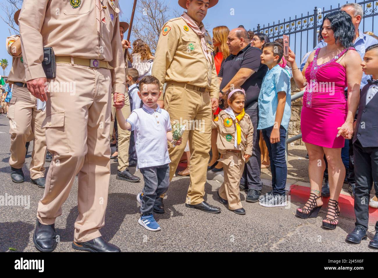 Haifa, Israël - 10 avril 2022 : les parents avec enfants et d'autres prennent part au défilé du dimanche des palmiers de Pâques de la communauté melkite catholique grecque, dans Banque D'Images