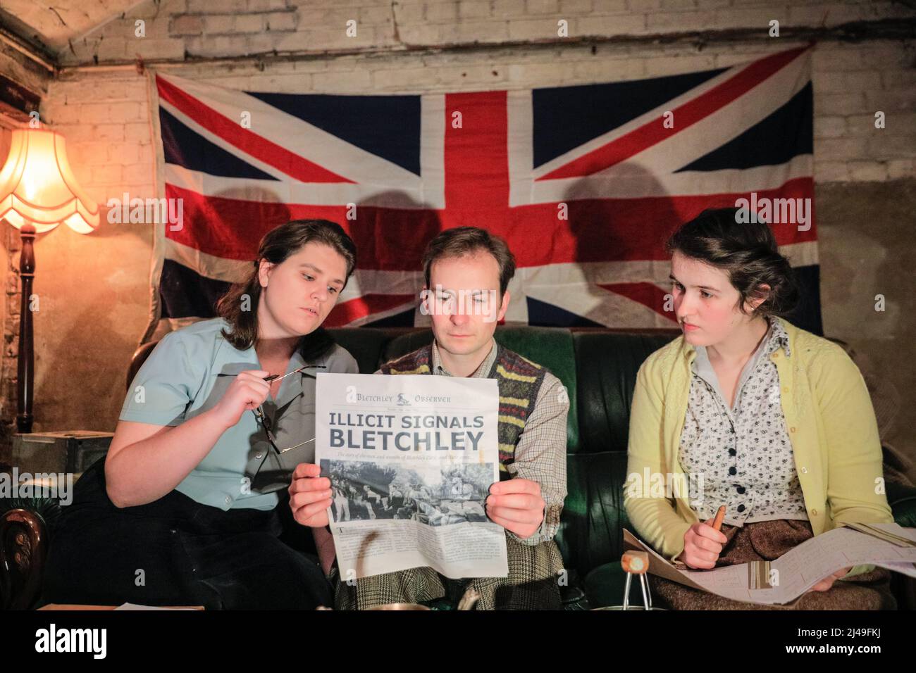 Londres, Royaume-Uni, 13th avril 2022. Amelia Stephenson, Timothy Styles et Beth Jay dans une scène sur le canapé. La société de théâtre immersive Parabolic Theatre présente la remise en état de leur succès "signaux illicites Bletchley". Le public peut interagir, se promener et travailler aux côtés de personnages célèbres du Code du gouvernement et de l'école Cipher à Bletchley Park pour craquer L'ÉNIGME, tandis que des secrets inconfortables plus proches de chez soi menacent d'être révélés. Le spectacle se déroule dans la NOUVELLE salle immersive DU Parabolic Theatre, AVEC Christopher Styles, Amelia Stephenson, Timothy Styles et Beth Jay. Banque D'Images