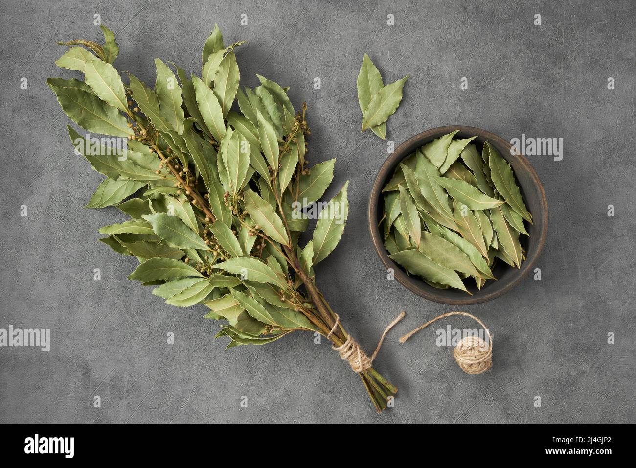 Bol de feuilles de Laurier séchées et bouquet de feuilles de Laurier vert sec, vue de dessus, plat. Banque D'Images