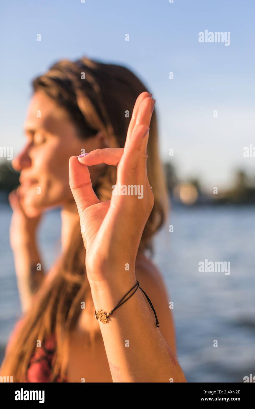 jeune femme en concentration profonde et en médiation sur une rive de rivière Banque D'Images