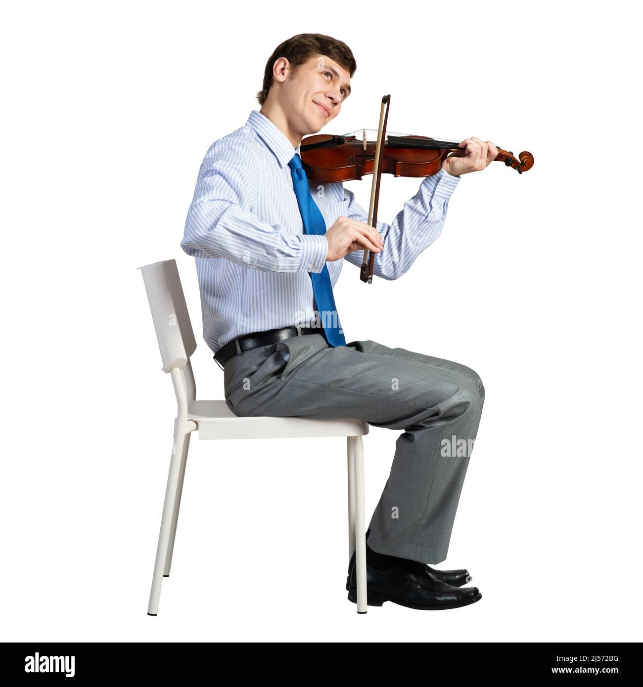 homme d'affaires sur une chaise avec violon Banque D'Images