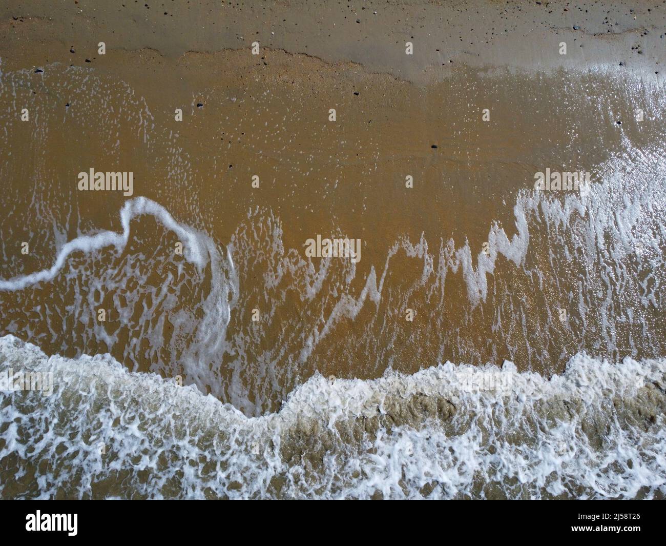 Vue aérienne sur les vagues blanches se lavant sur la plage Banque D'Images