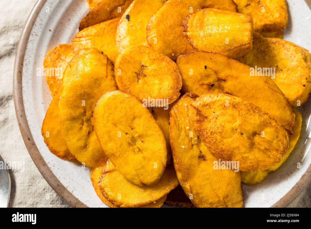 Des plantains frits faits maison avec sel et poivre Banque D'Images