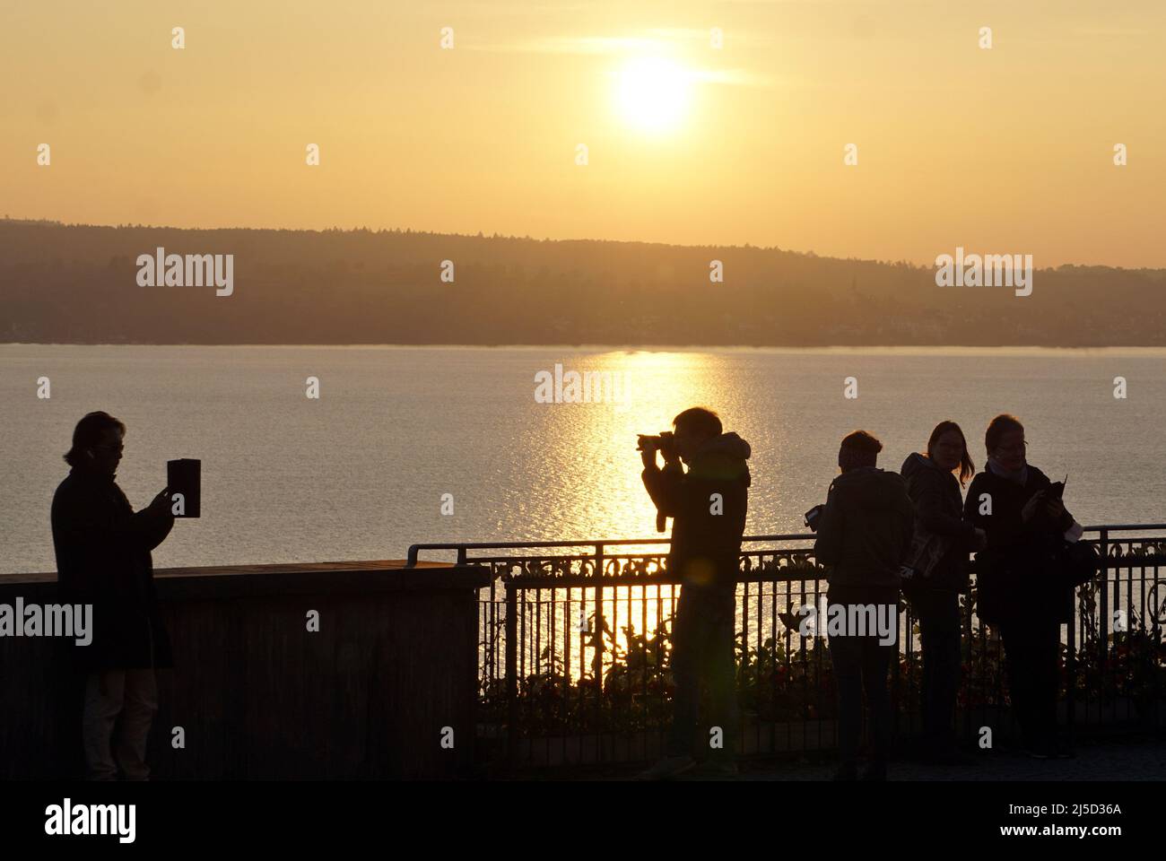 Birnau 10.10.2020 - Un homme et une femme prennent des photos avec un smartphone et une tablette pendant le coucher du soleil. [traduction automatique] Banque D'Images