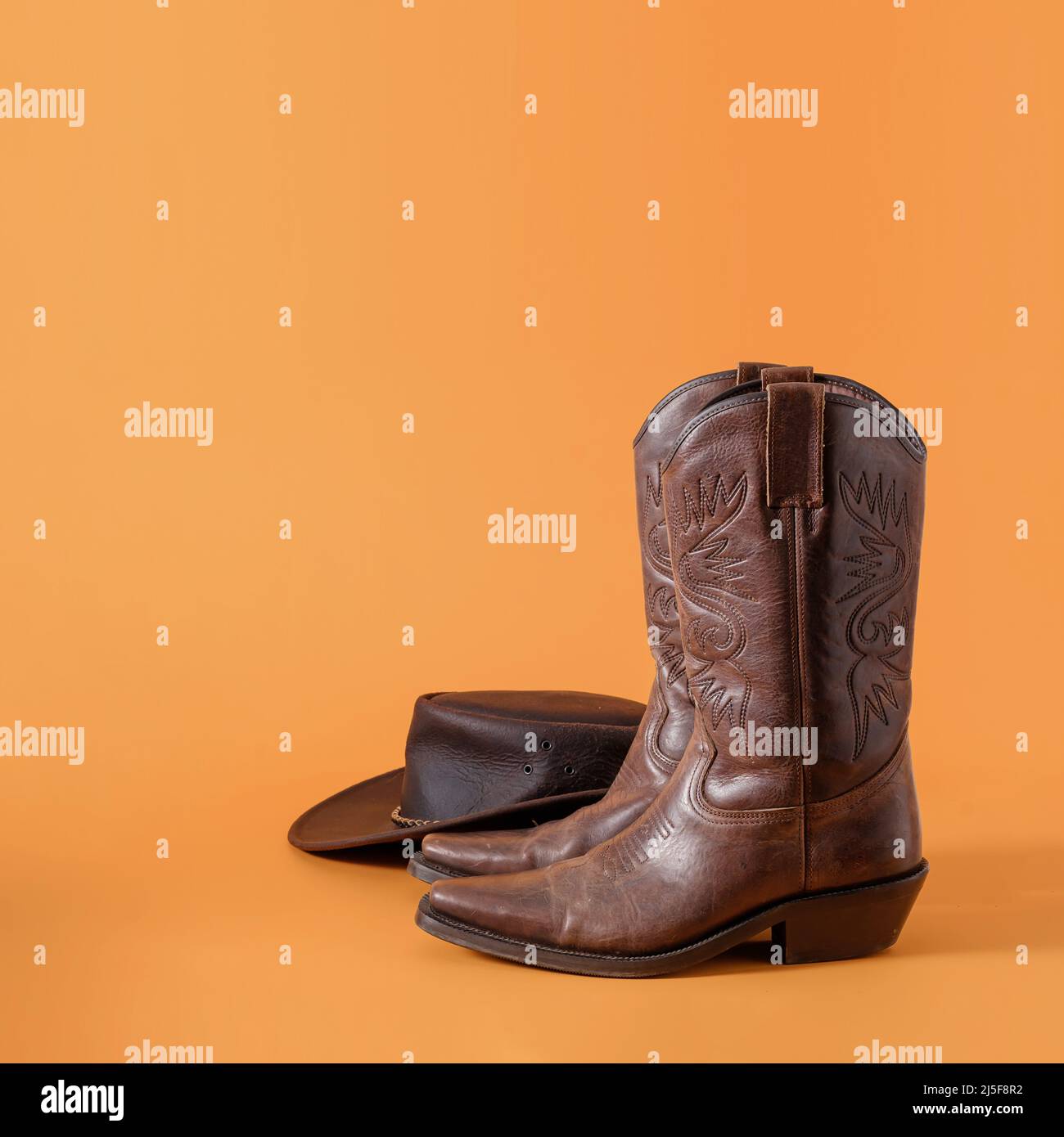 Bottes et chapeau de cowboy sauvage d'amérique de l'Ouest du texas comme concept créatif minimal et symbole de rodéo rural et de ferme. Banque D'Images