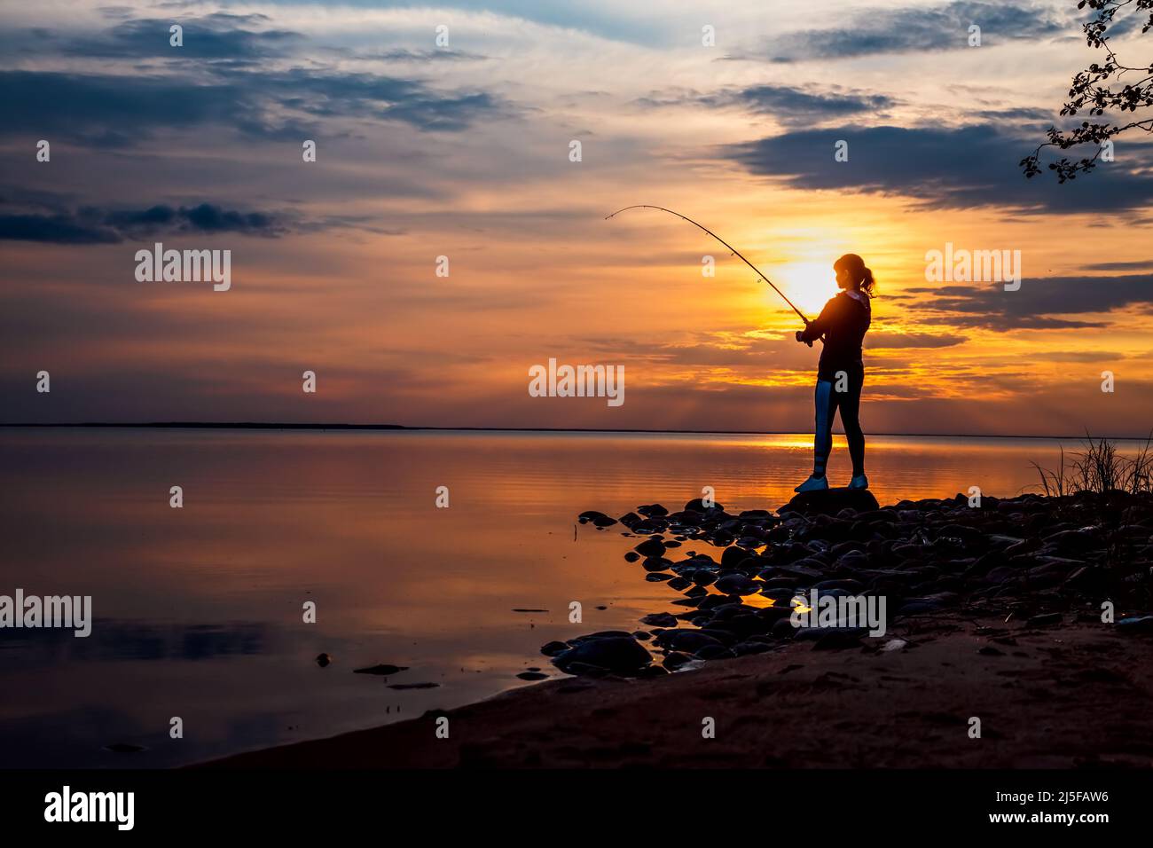 Pêche à la femme sur la canne à pêche spinning en Finlande Banque D'Images