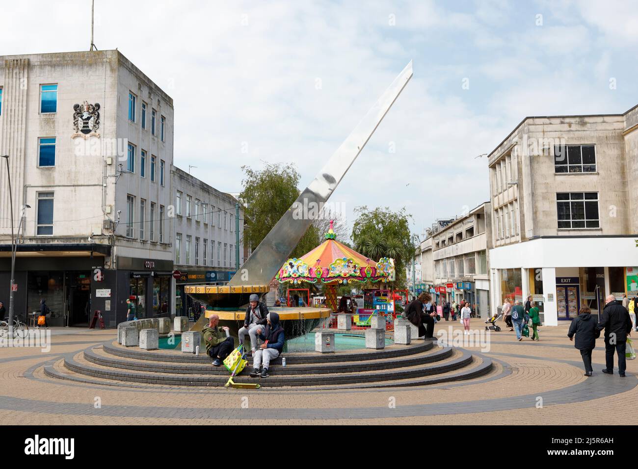 Plymouth, Devon, Royaume-Uni. 25th avril 2022. Une journée de printemps ensoleillée dans le centre de Plymouth. Les gens s'assoient sur les marches du Sundial sur Armada Way à Plymouth. Banque D'Images