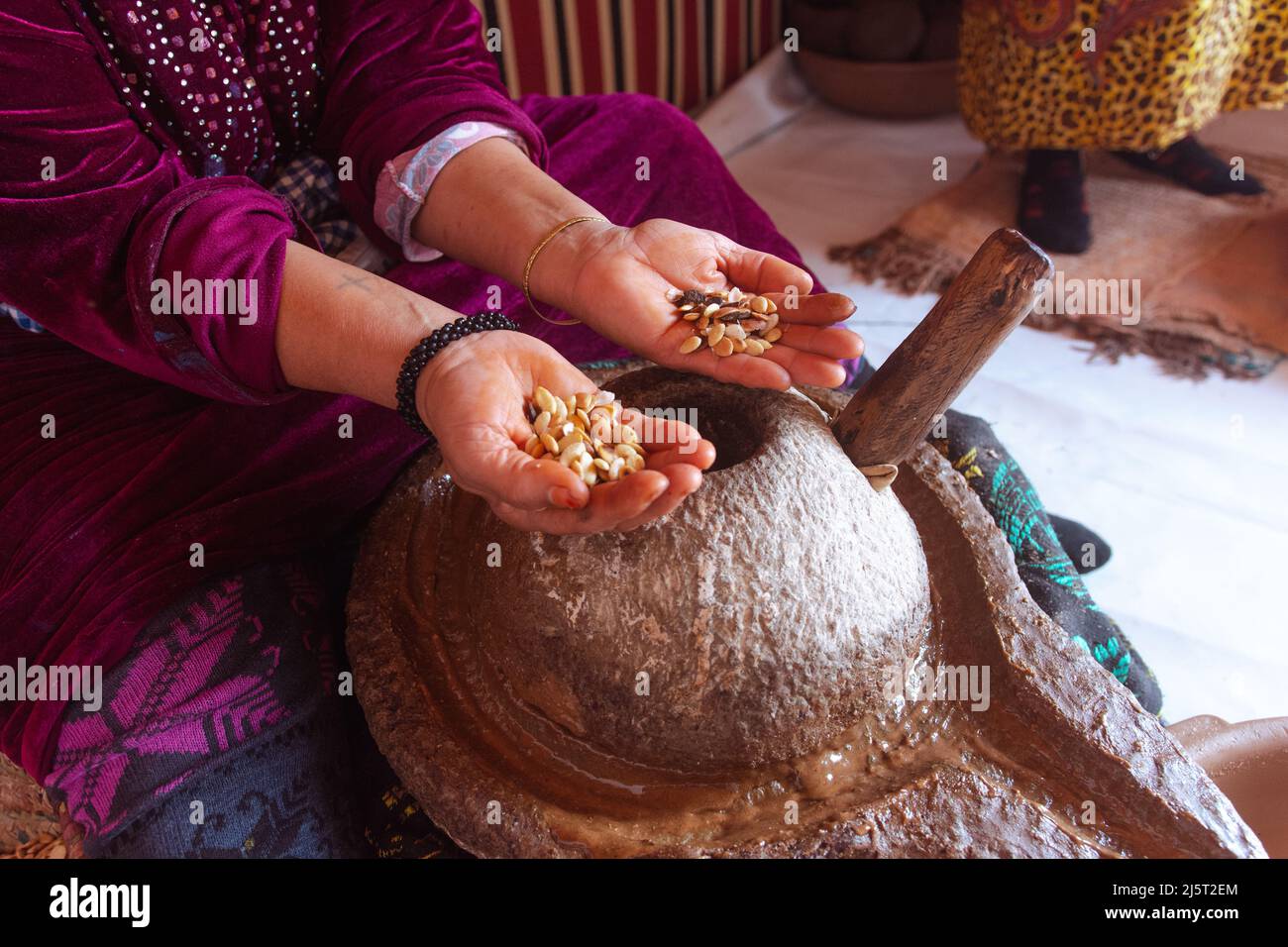 Femmes qui font de l'huile d'argan, Maroc. Tenant les graines avec ses mains. Des gens réels qui font des choses réelles. Afrique Banque D'Images