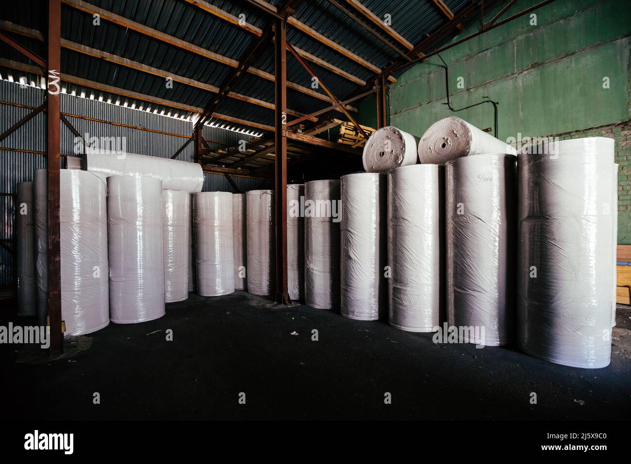 Rouleaux de papier recyclé dans l'entrepôt. Banque D'Images