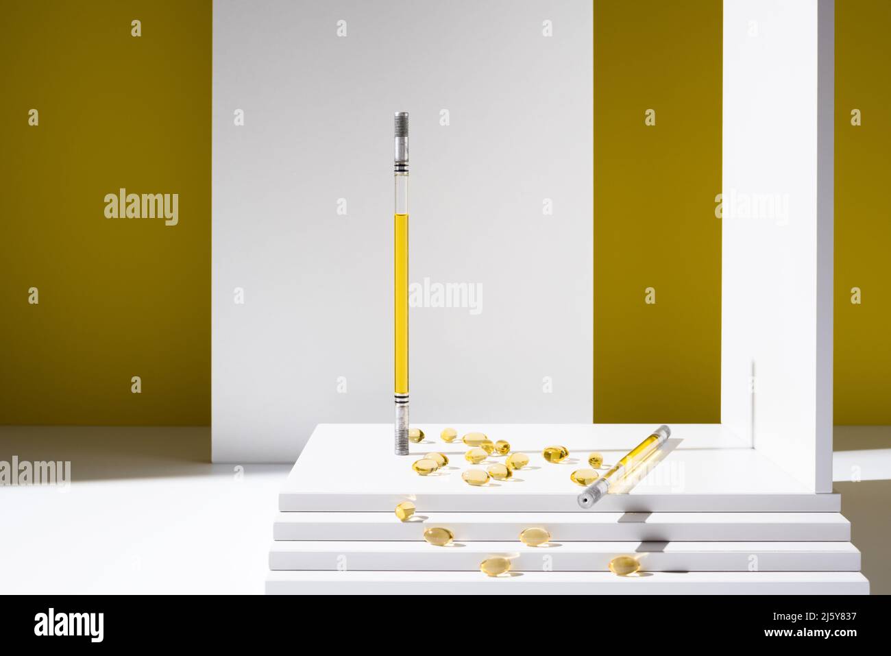 Récipients en verre contenant de l'huile pour la production de produits de soins de la peau et capsules d'oméga comme vitamines pour la santé dispersés dans un studio élégant Banque D'Images