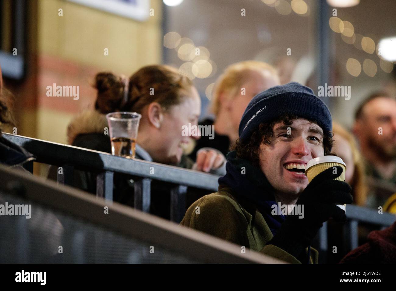Fan de football masculin vêt d'hiver et tenant une boisson chaude au Hamlet de Dulwich Banque D'Images