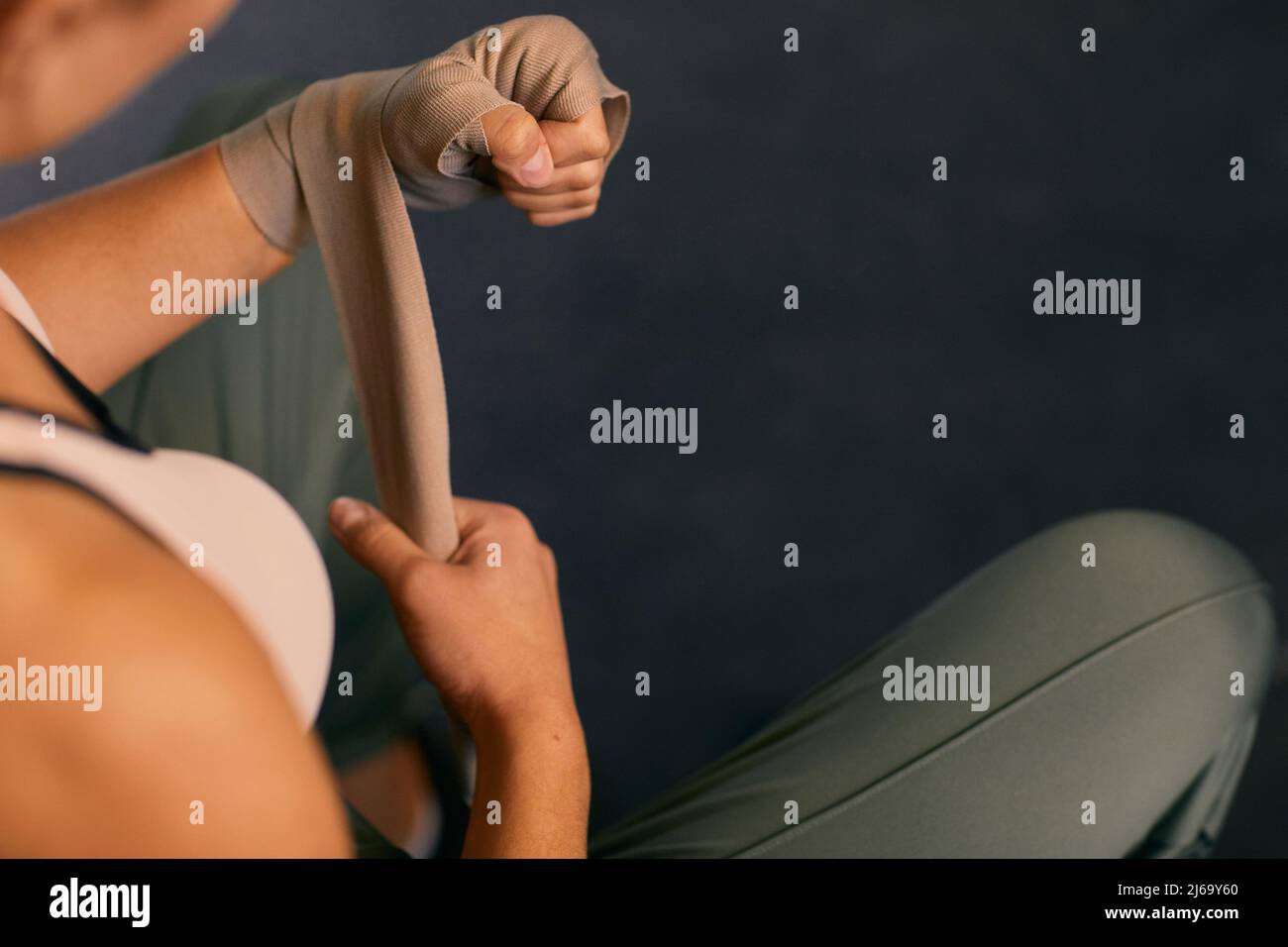 Prise de vue en grand angle d'une femme méconnue qui enveloppe ses mains avec un bandage élastique Banque D'Images