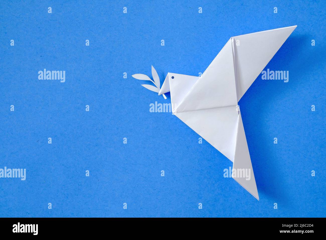 Colombe de la paix sur fond bleu ciel concept de l'origami jouet loisirs et passe-temps et affiche avec emblème non à la guerre et oui à la paix. Banque D'Images