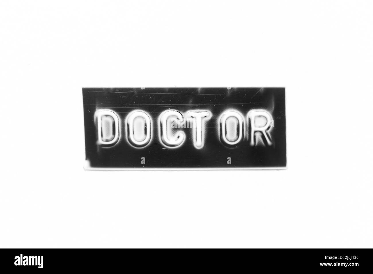 Bannière noire avec lettre en relief avec le mot médecin sur fond de papier blanc Banque D'Images